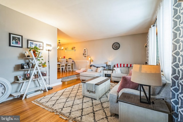 living room featuring hardwood / wood-style floors and a notable chandelier