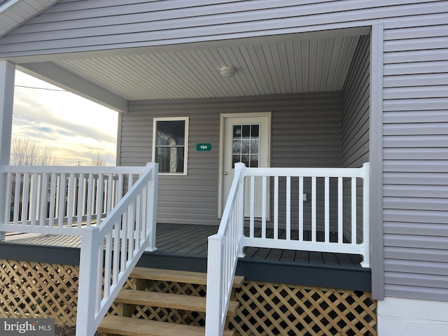 exterior entry at dusk featuring covered porch