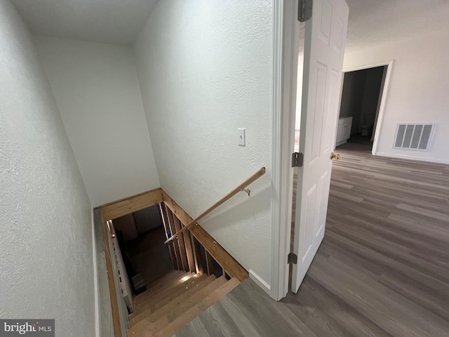 stairway featuring hardwood / wood-style flooring