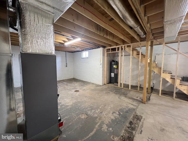 basement featuring heating unit and water heater