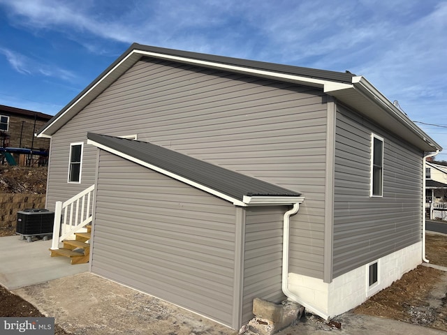 view of side of property with central AC unit