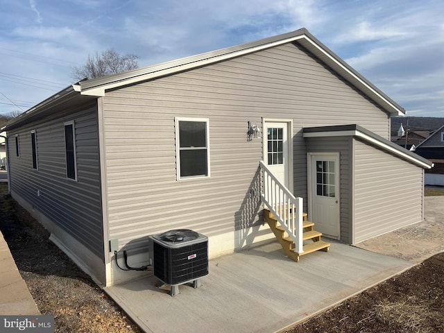 rear view of house with central AC