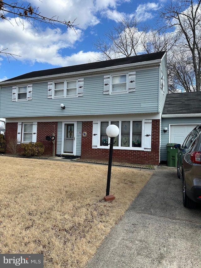 view of front of property with a garage and a front yard