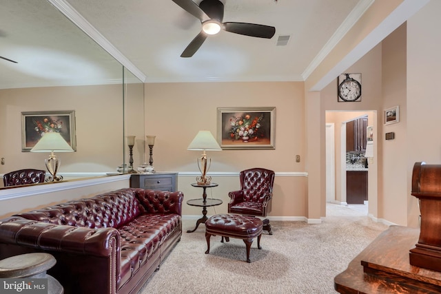 carpeted living room with ceiling fan and ornamental molding