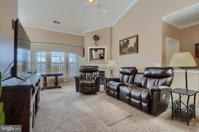 living room with ornamental molding, ceiling fan, and carpet flooring