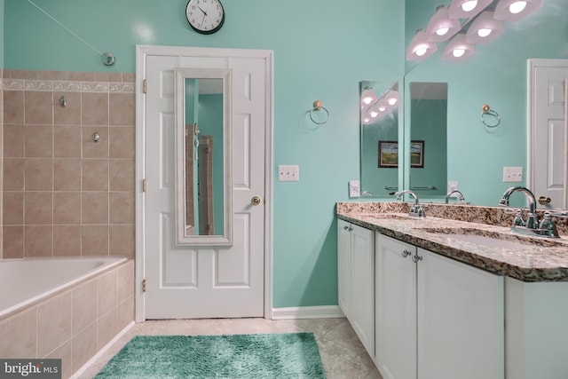 bathroom with vanity, tile patterned floors, and tiled shower / bath