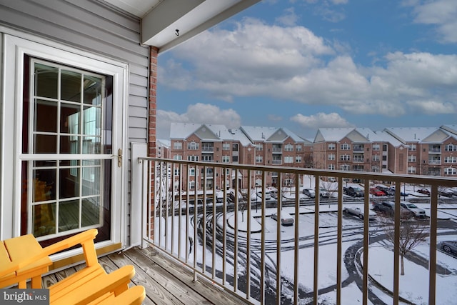 view of snow covered back of property