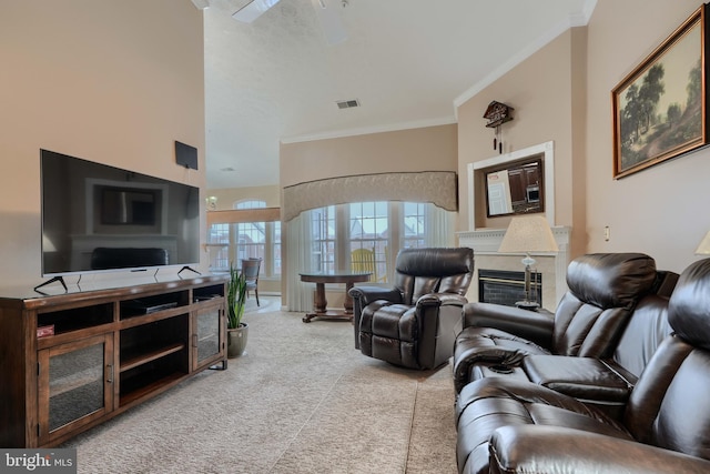 carpeted living room featuring crown molding, a towering ceiling, and ceiling fan