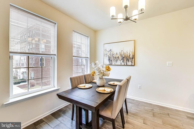 dining area with a notable chandelier and light wood-type flooring