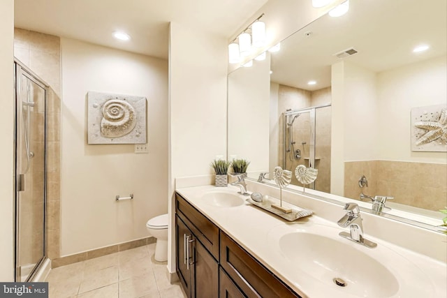 bathroom with vanity, toilet, an enclosed shower, and tile patterned flooring