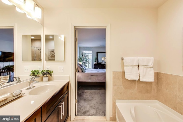 bathroom featuring vanity, a tub to relax in, and tile patterned flooring