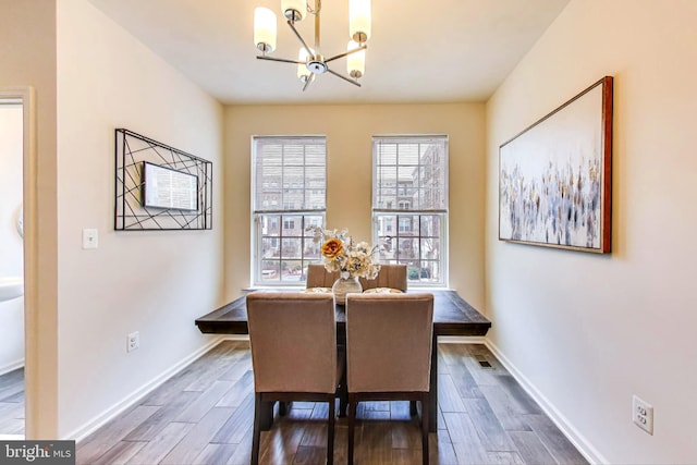 dining room featuring dark hardwood / wood-style floors and a chandelier