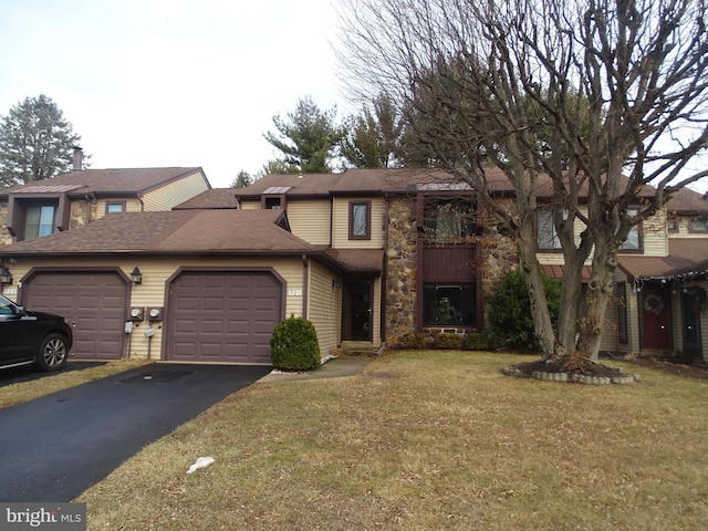 view of front of house featuring a garage and a front lawn