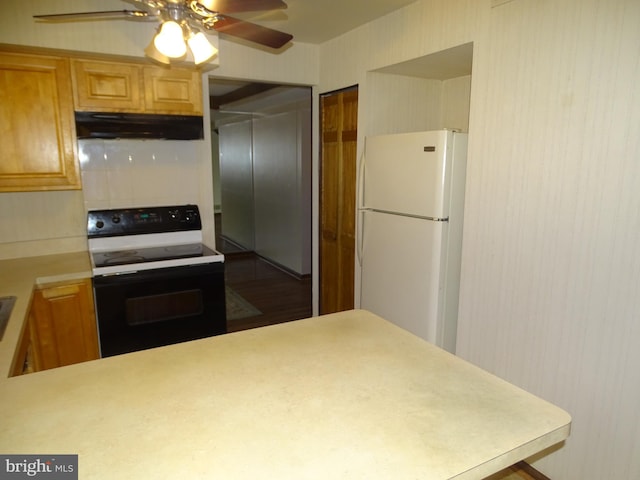 kitchen with ceiling fan, black electric range oven, and white fridge