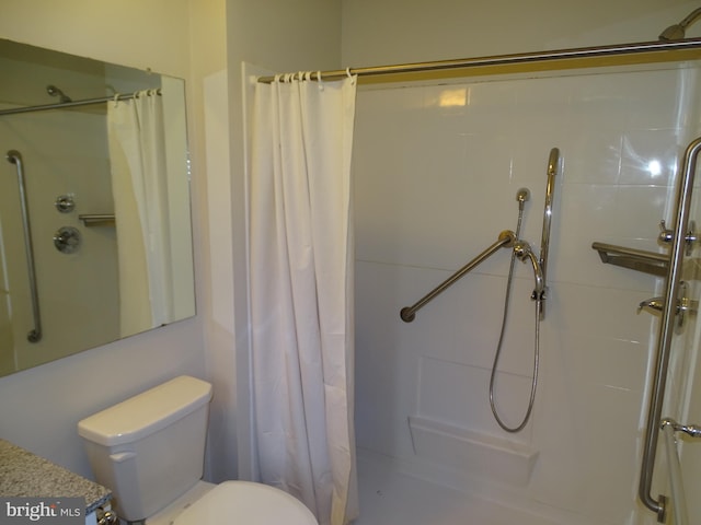 bathroom featuring toilet and a shower with curtain