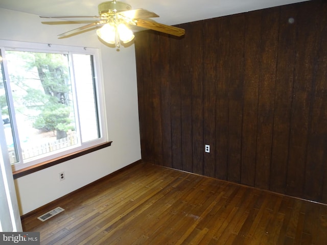 spare room featuring ceiling fan and dark hardwood / wood-style flooring