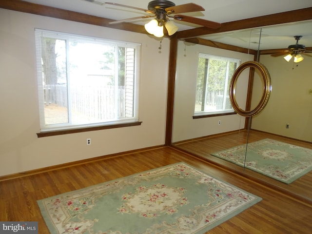 interior space featuring wood-type flooring and ceiling fan