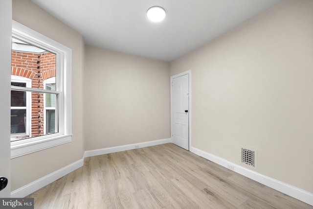 spare room with light wood-type flooring