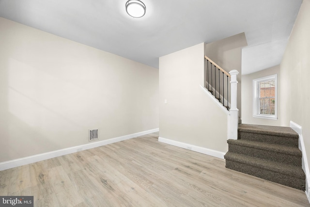 staircase with wood-type flooring