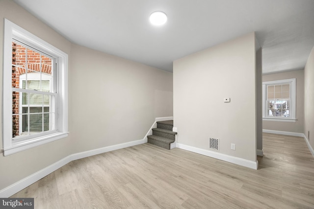 spare room with light hardwood / wood-style flooring