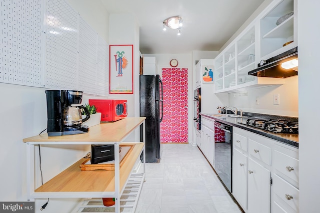 kitchen featuring sink, black appliances, and white cabinets