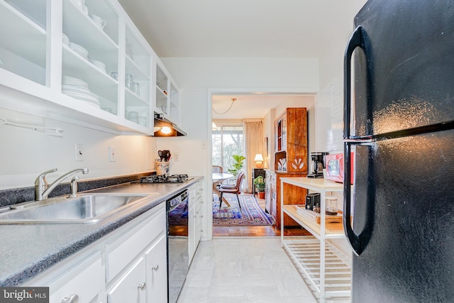 kitchen with white cabinetry, sink, and black appliances