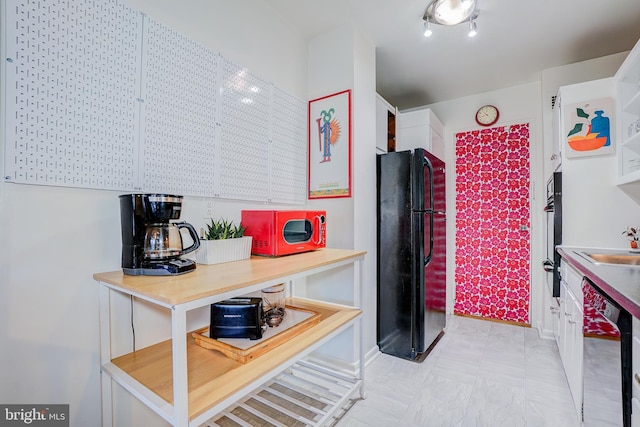 kitchen with sink and black appliances