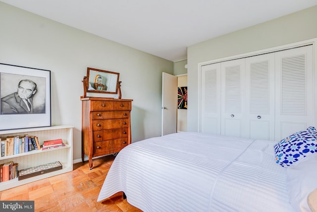 bedroom with a closet and light parquet floors