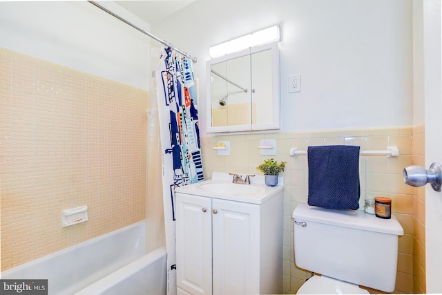 full bathroom with vanity, tile walls, shower / tub combo with curtain, and toilet