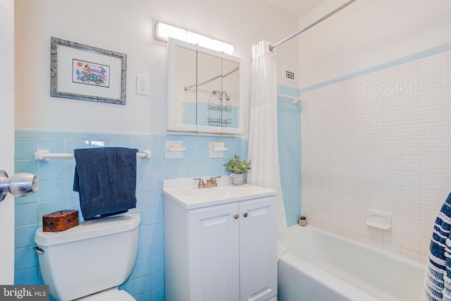 full bathroom featuring vanity, tile walls, shower / bathtub combination with curtain, and toilet