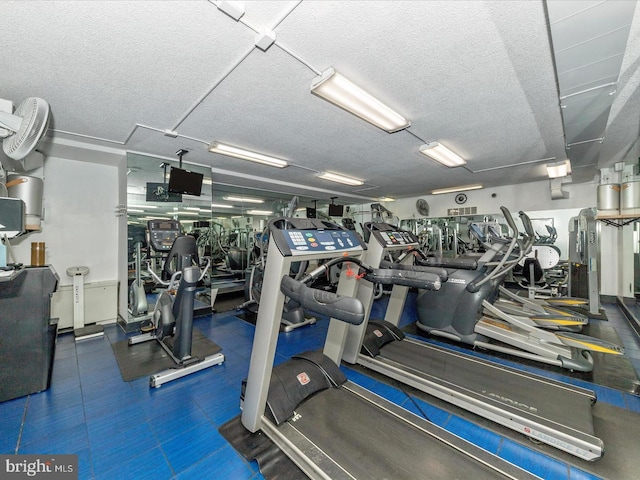 exercise room with a textured ceiling