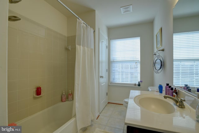 full bathroom with tile patterned flooring, vanity, shower / bath combo with shower curtain, and toilet