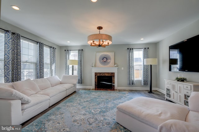 living room with an inviting chandelier and hardwood / wood-style floors