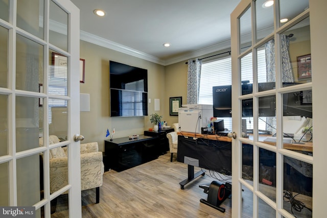 home office with crown molding, hardwood / wood-style floors, and french doors