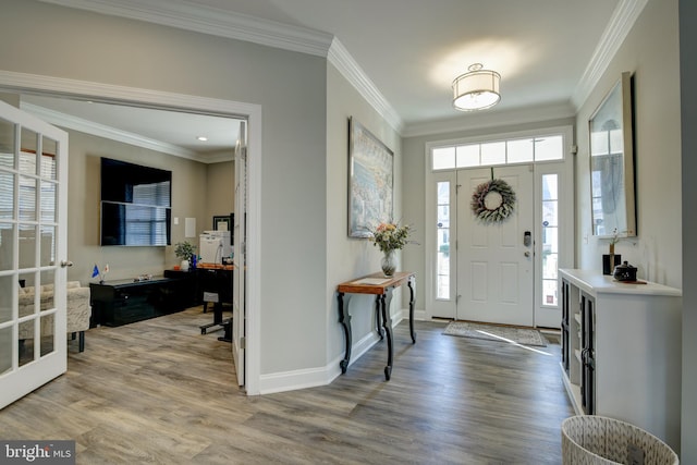 entrance foyer with wood-type flooring and ornamental molding