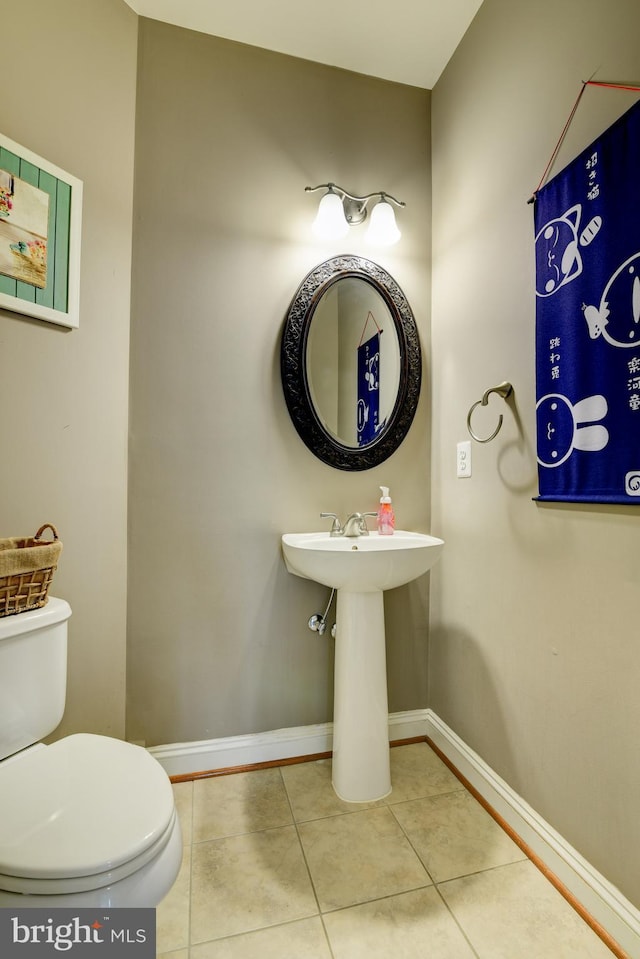 bathroom featuring toilet and tile patterned flooring