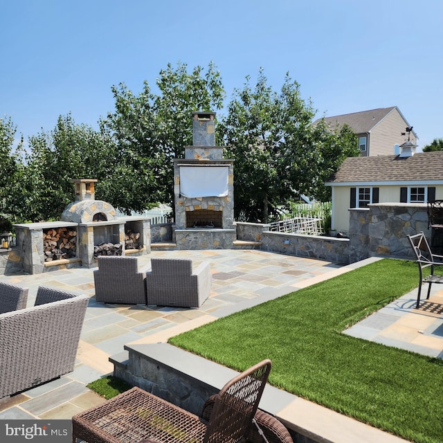 view of patio / terrace with an outdoor living space with a fireplace