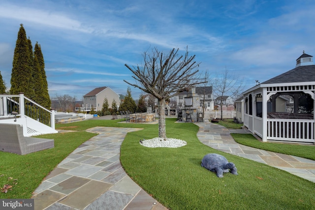 surrounding community with a patio, a gazebo, and a lawn