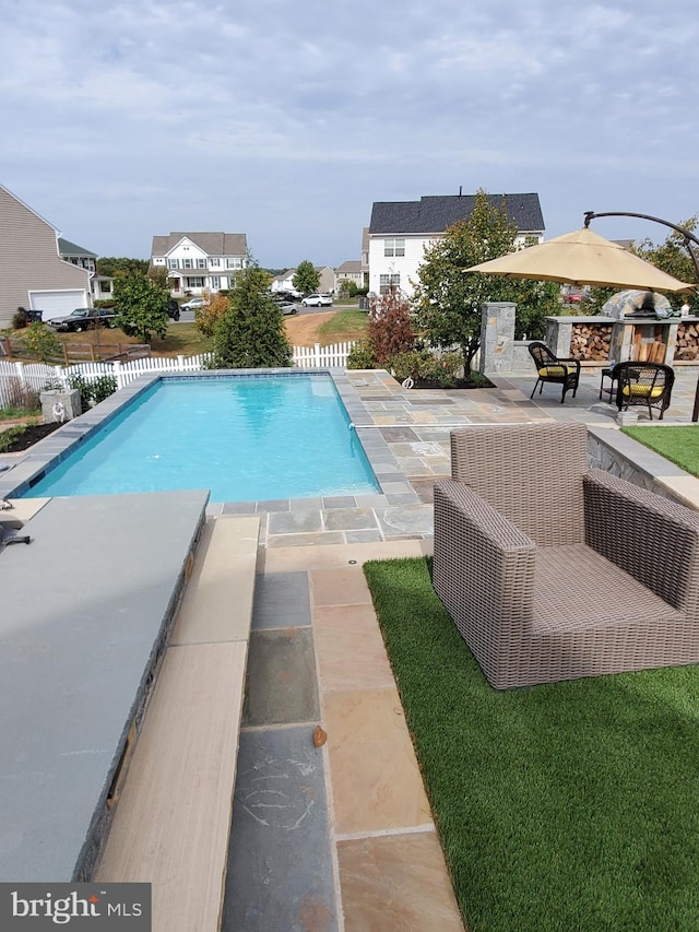 view of swimming pool with a patio