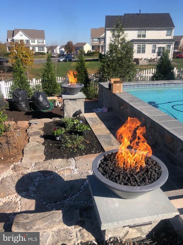 view of swimming pool featuring a fire pit