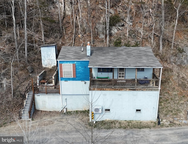 view of side of property with crawl space and a chimney