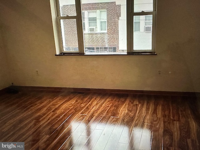 empty room with dark wood-type flooring