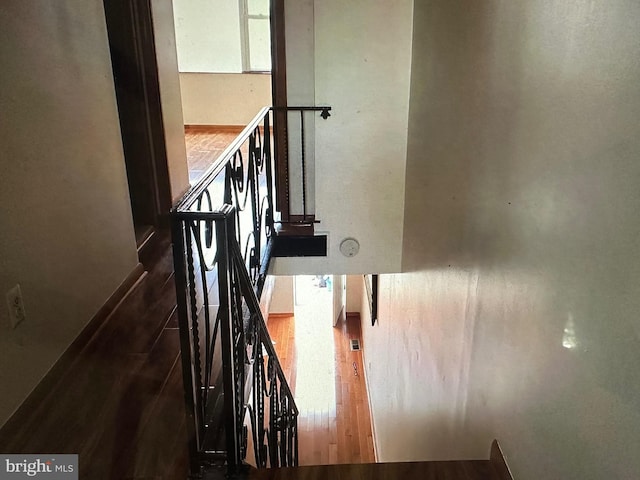 staircase with hardwood / wood-style flooring