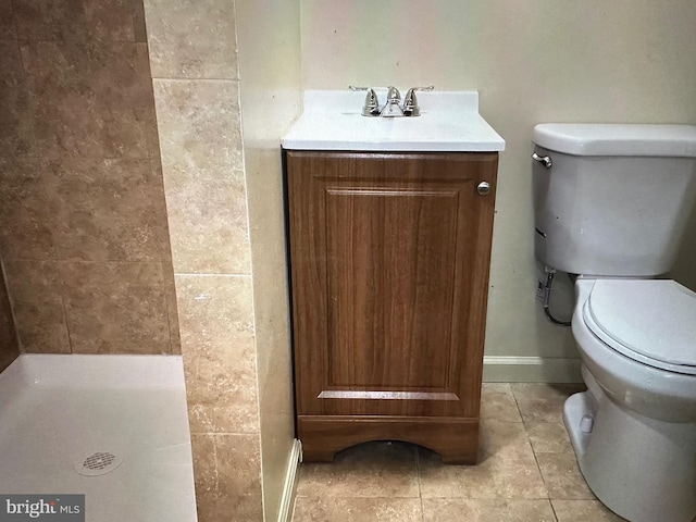 bathroom featuring tile patterned flooring, vanity, and toilet