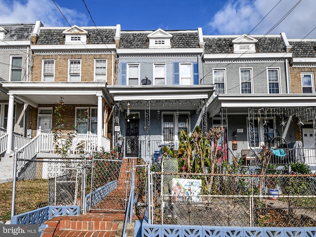 townhome / multi-family property with covered porch