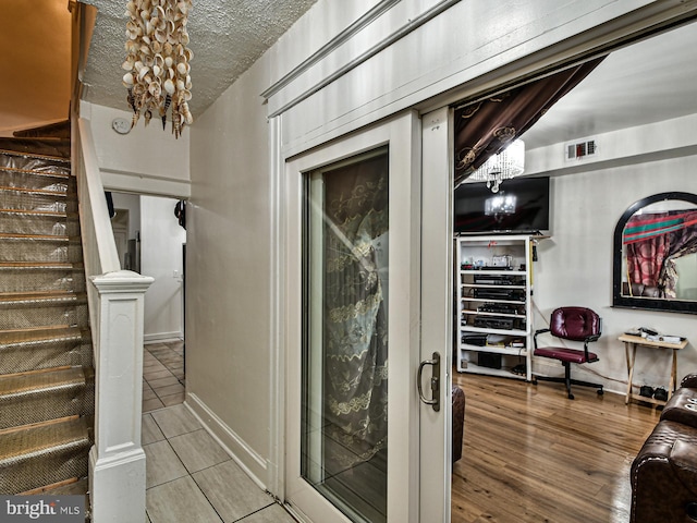 interior space featuring hardwood / wood-style flooring and a textured ceiling