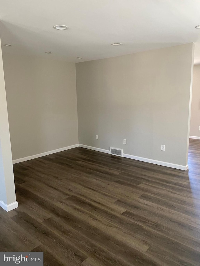 spare room with dark hardwood / wood-style floors