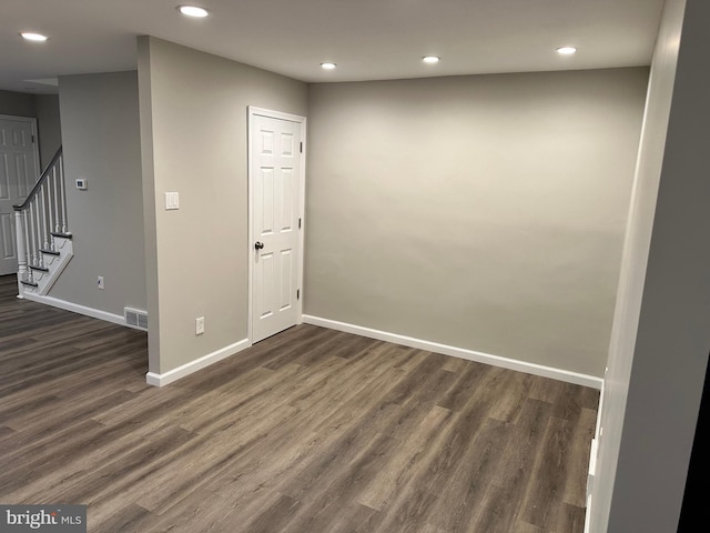 unfurnished room with dark wood-type flooring