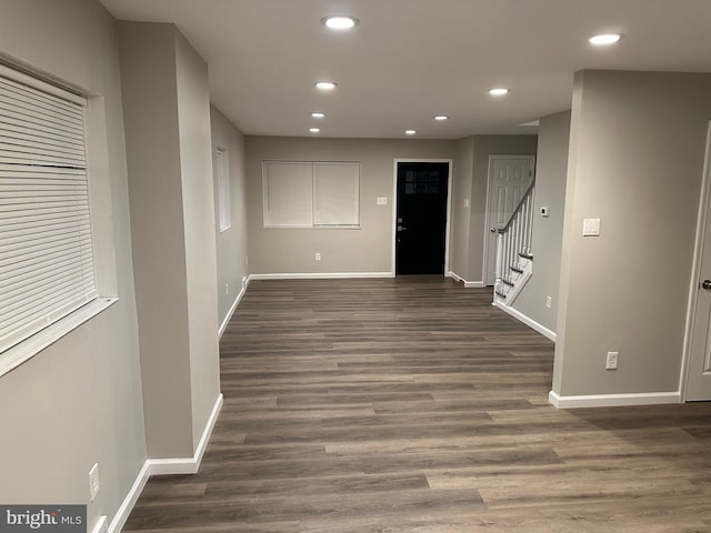 hallway with dark hardwood / wood-style flooring