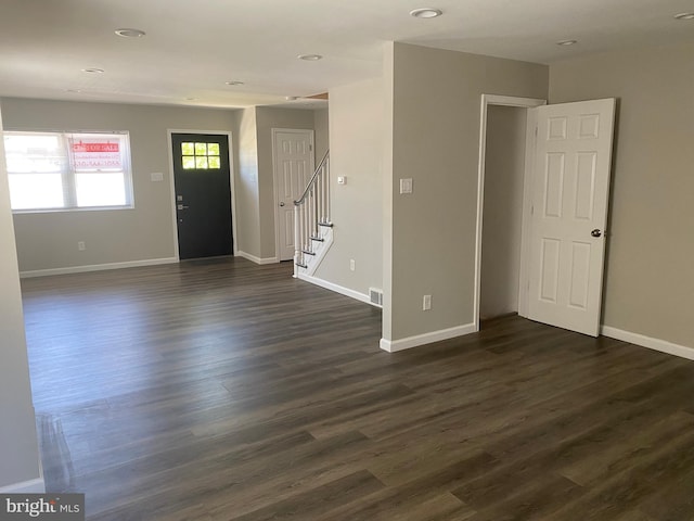 spare room with dark hardwood / wood-style floors